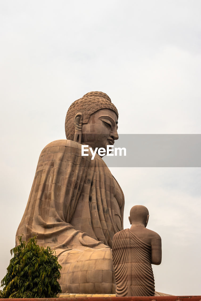 LOW ANGLE VIEW OF STATUE AGAINST CATHEDRAL AGAINST SKY