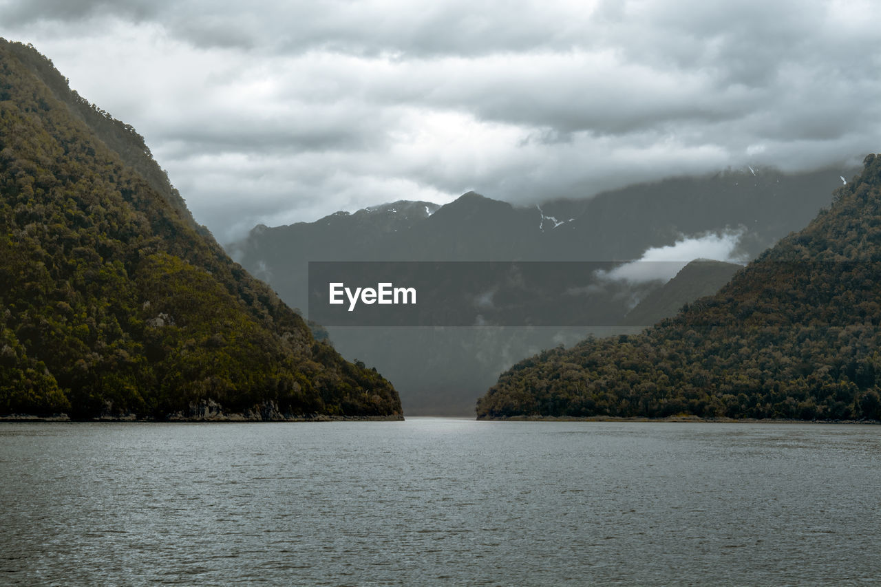 Scenic view of lake and mountains against sky