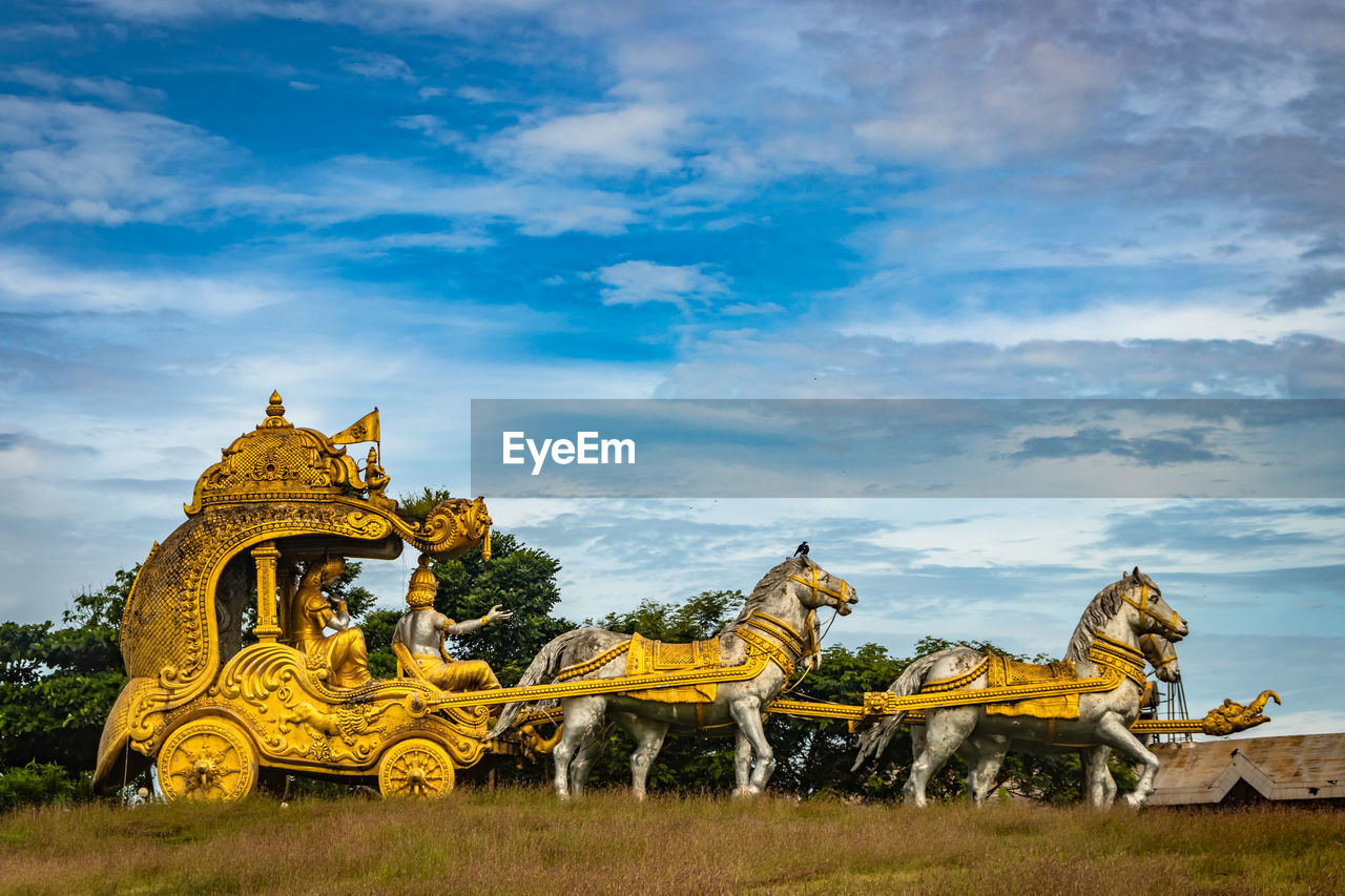 Holly arjuna chariot of mahabharata in golden color with amazing sky background