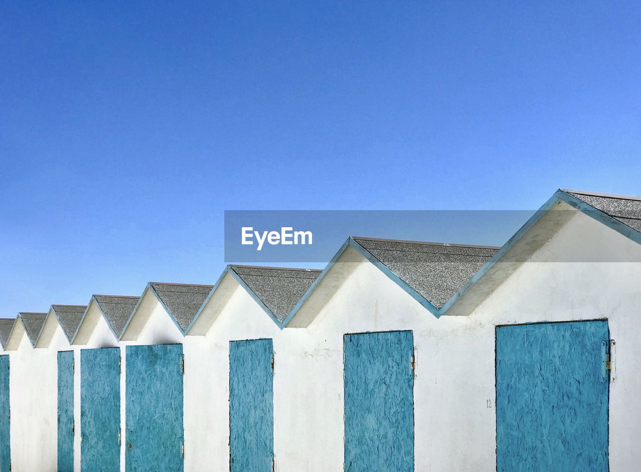 Low angle view of beach houses against blue sky