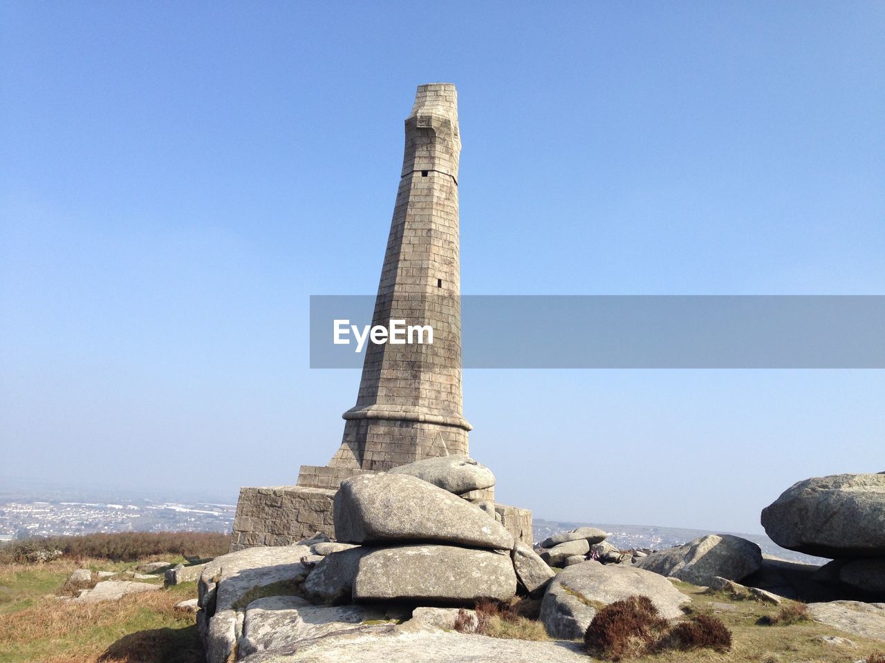Column on field against clear sky