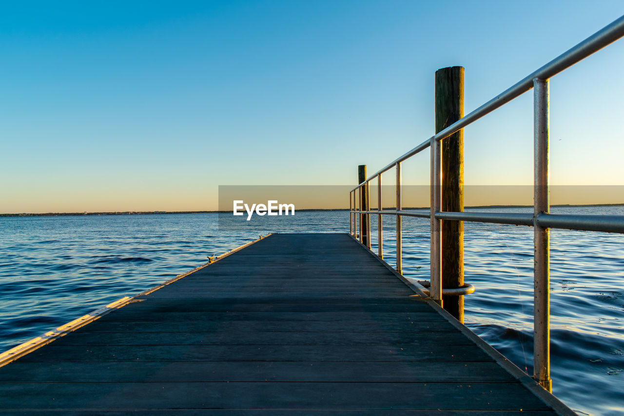 Pier over sea against clear sky