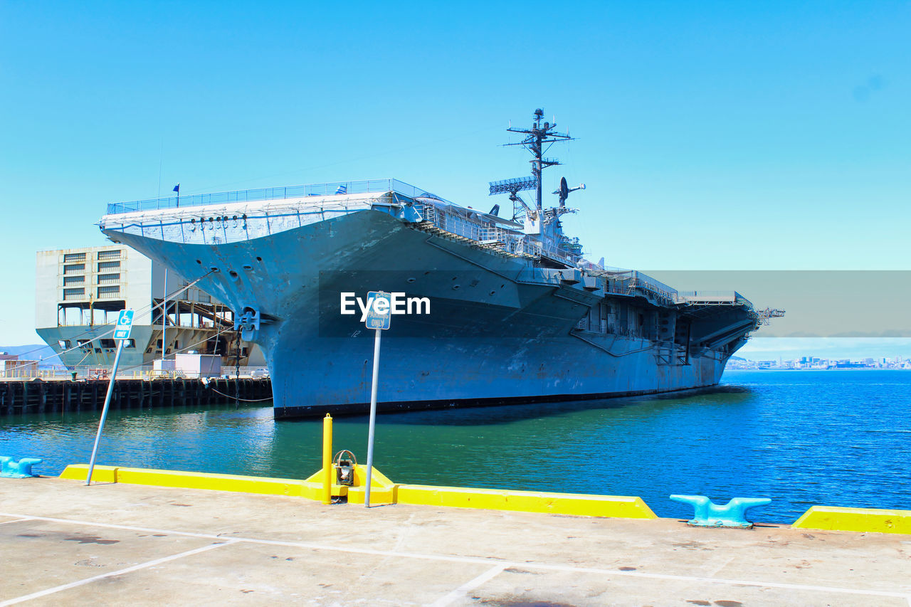 SHIP MOORED ON SEA AGAINST CLEAR SKY