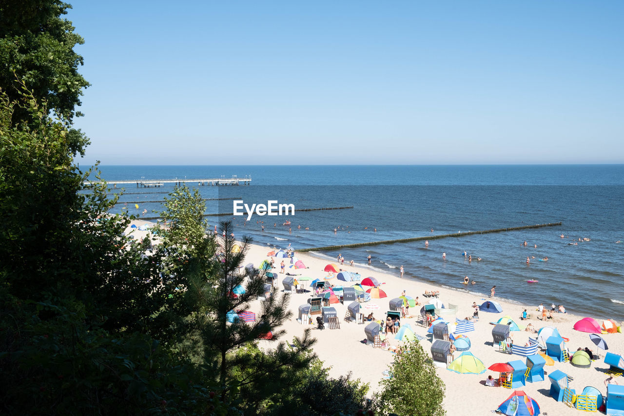 High angle view of people at beach against sky