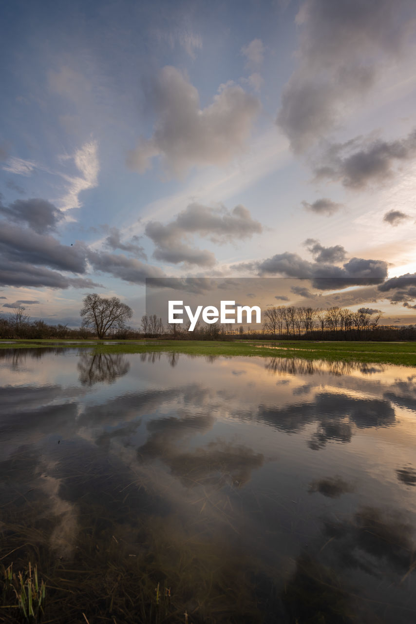 Scenic view of lake against sky during sunset