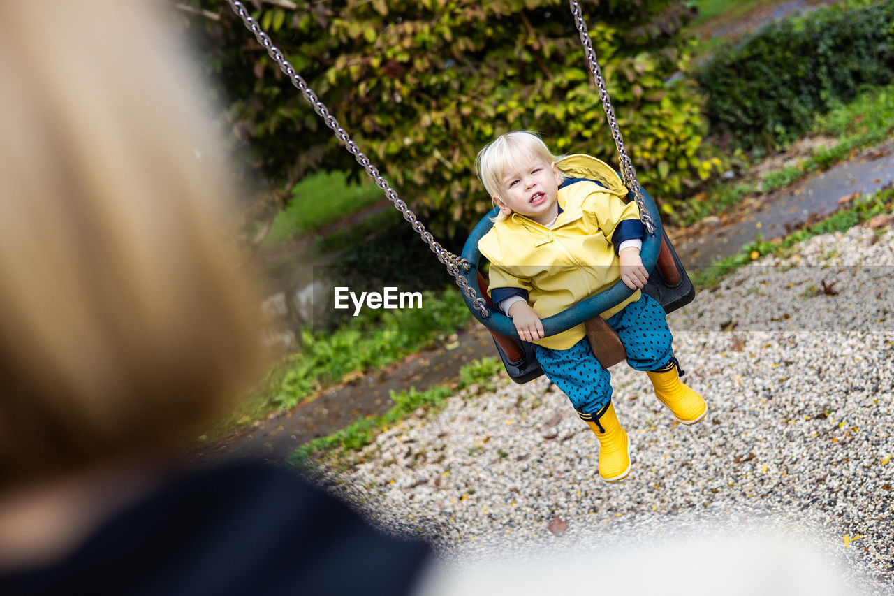 high angle view of boy swinging at playground