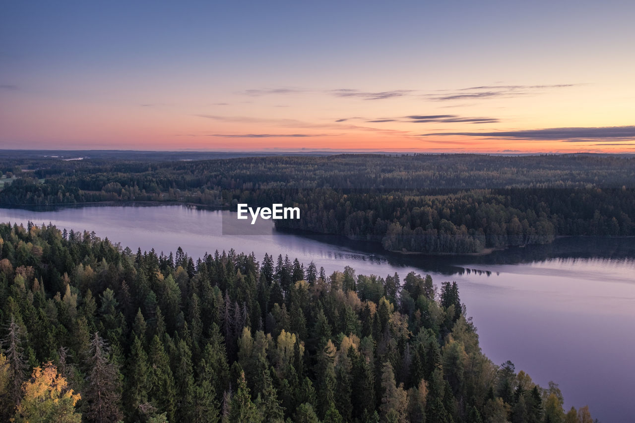 Scenic view of lake and trees during sunset
