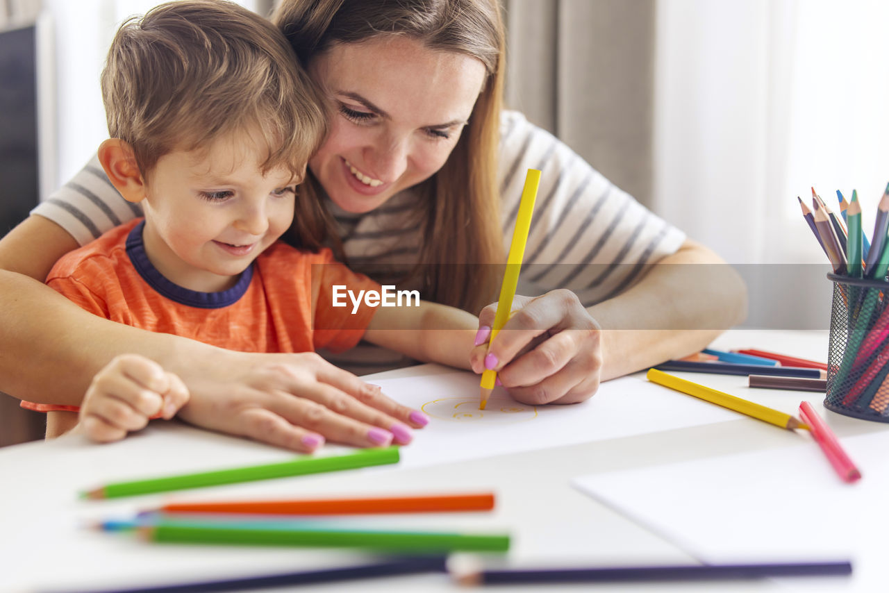 boy drawing on book