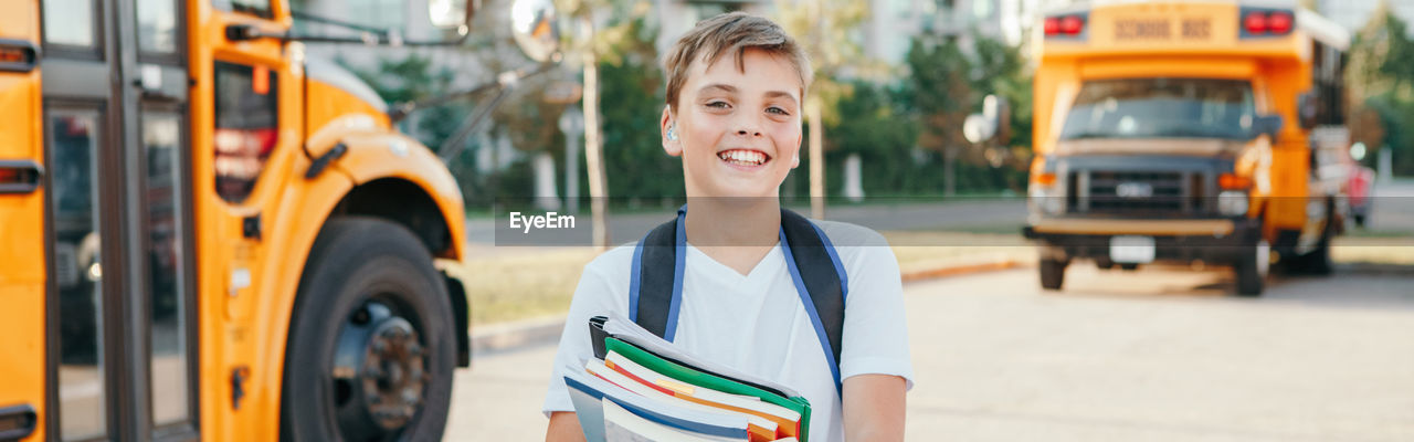 Portrait of smiling boy in city