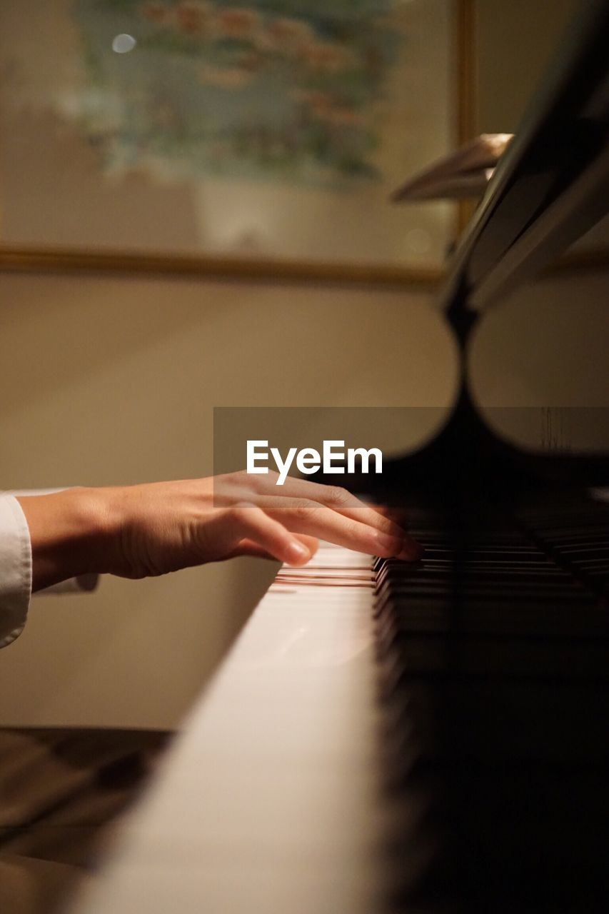 Close-up of hands playing piano