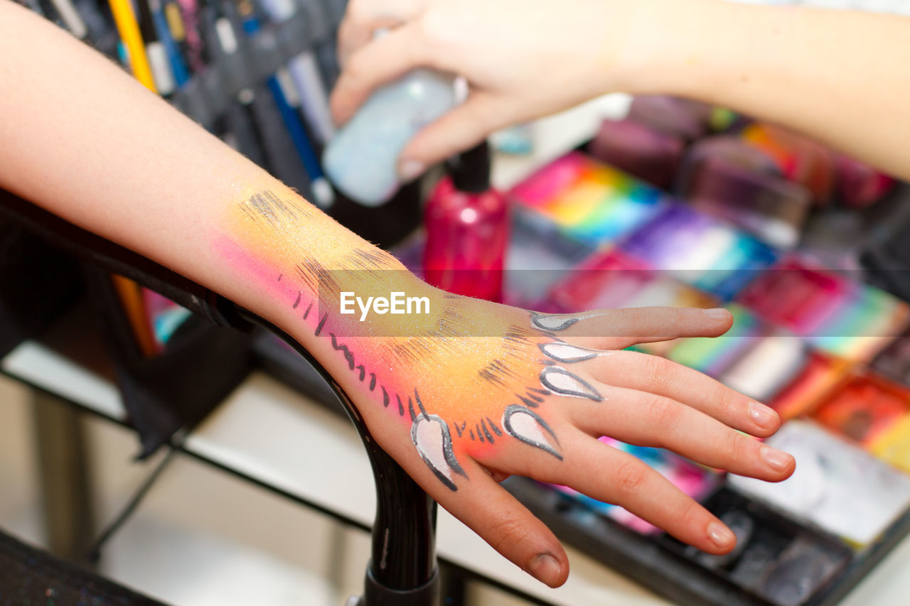 Close-up of woman hand with colorful tattoo