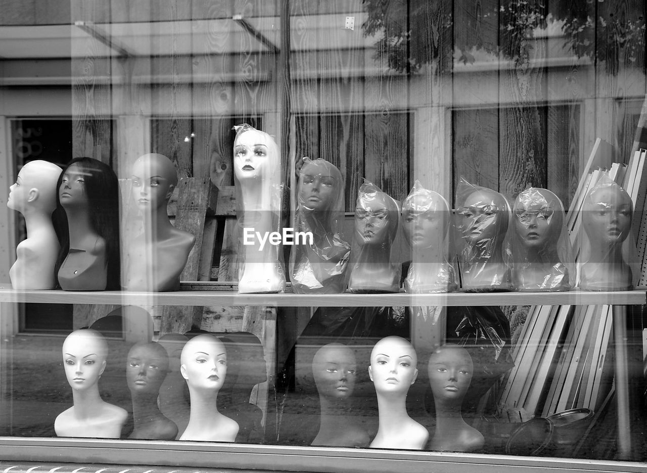 Mannequins in store seen through window