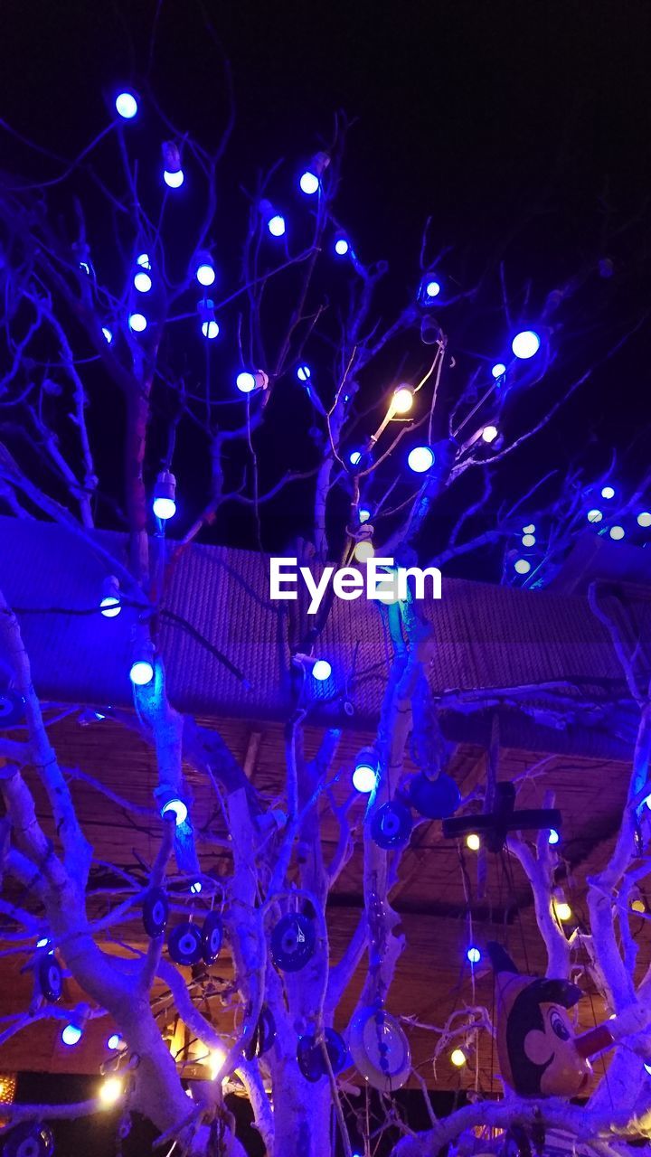 LOW ANGLE VIEW OF ILLUMINATED LANTERNS HANGING AT NIGHT