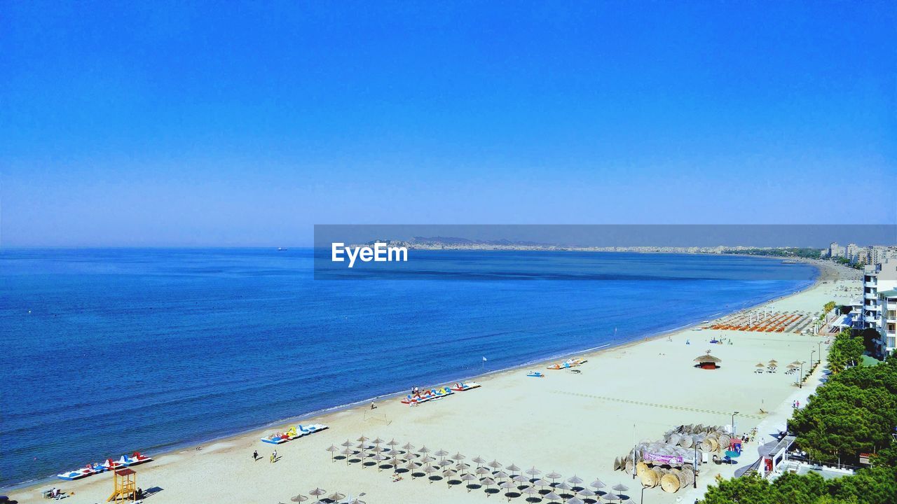 High angle view of sea against clear blue sky