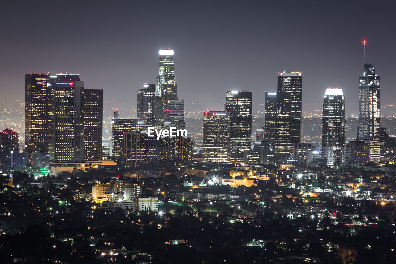 Aerial view of city lit up at night