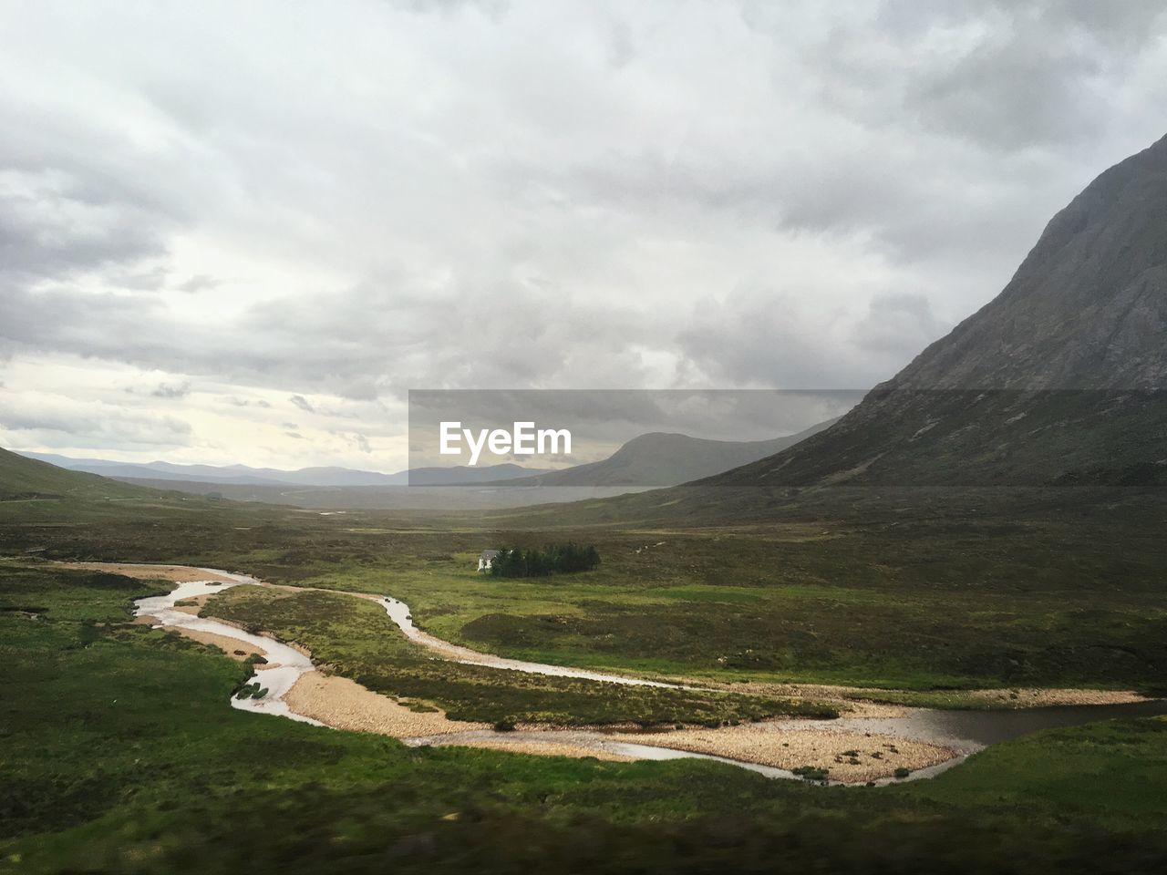 Scenic view of scottish landscape by lake against sky