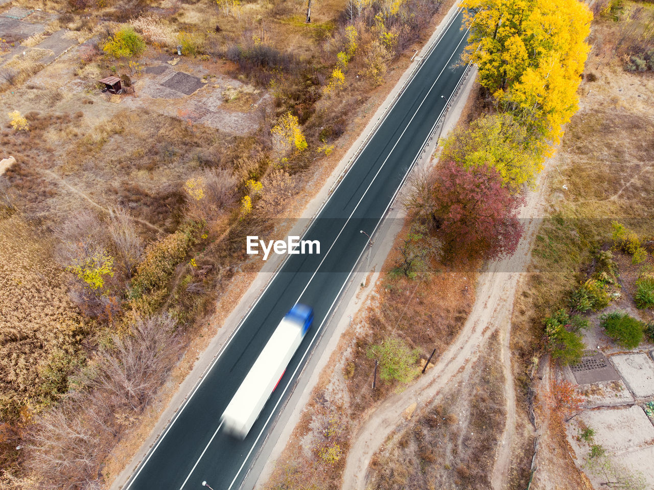 HIGH ANGLE VIEW OF ROAD PASSING THROUGH LANDSCAPE