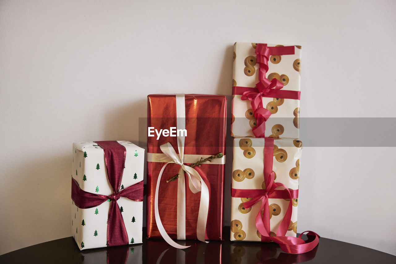 Four christmas presents on table