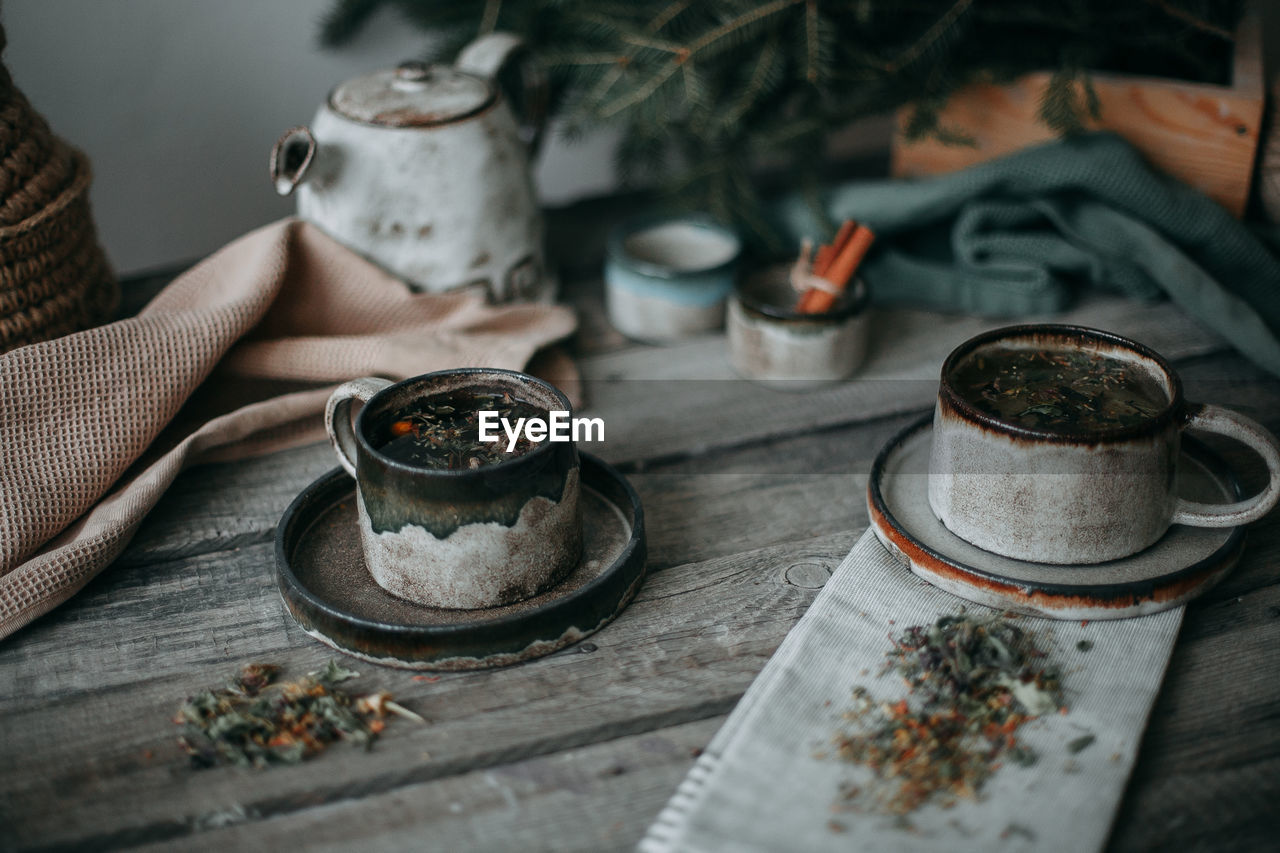 Ceramic mugs with tea on a wooden table