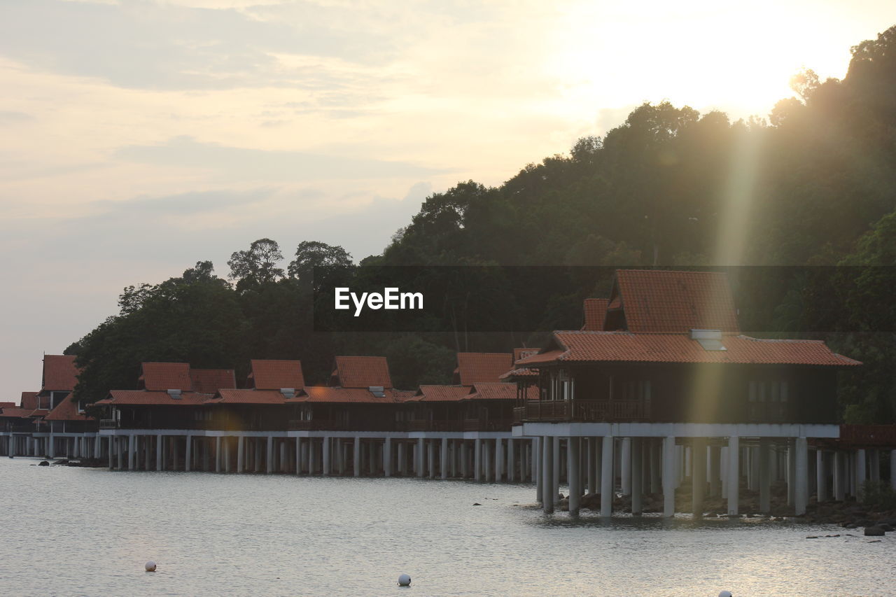 Built structures against sky during sunset