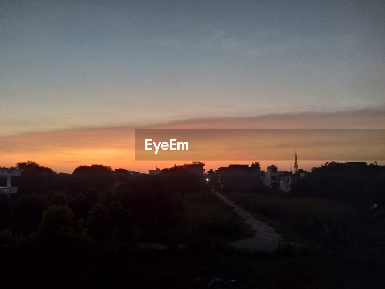 sky, sunset, dawn, horizon, environment, landscape, nature, evening, architecture, afterglow, scenics - nature, beauty in nature, sunlight, cloud, city, no people, silhouette, tranquility, sun, built structure, hill, tree, darkness, building, outdoors, orange color, tranquil scene, building exterior, plant, land, red sky at morning, travel destinations, copy space, idyllic, light, travel, dramatic sky