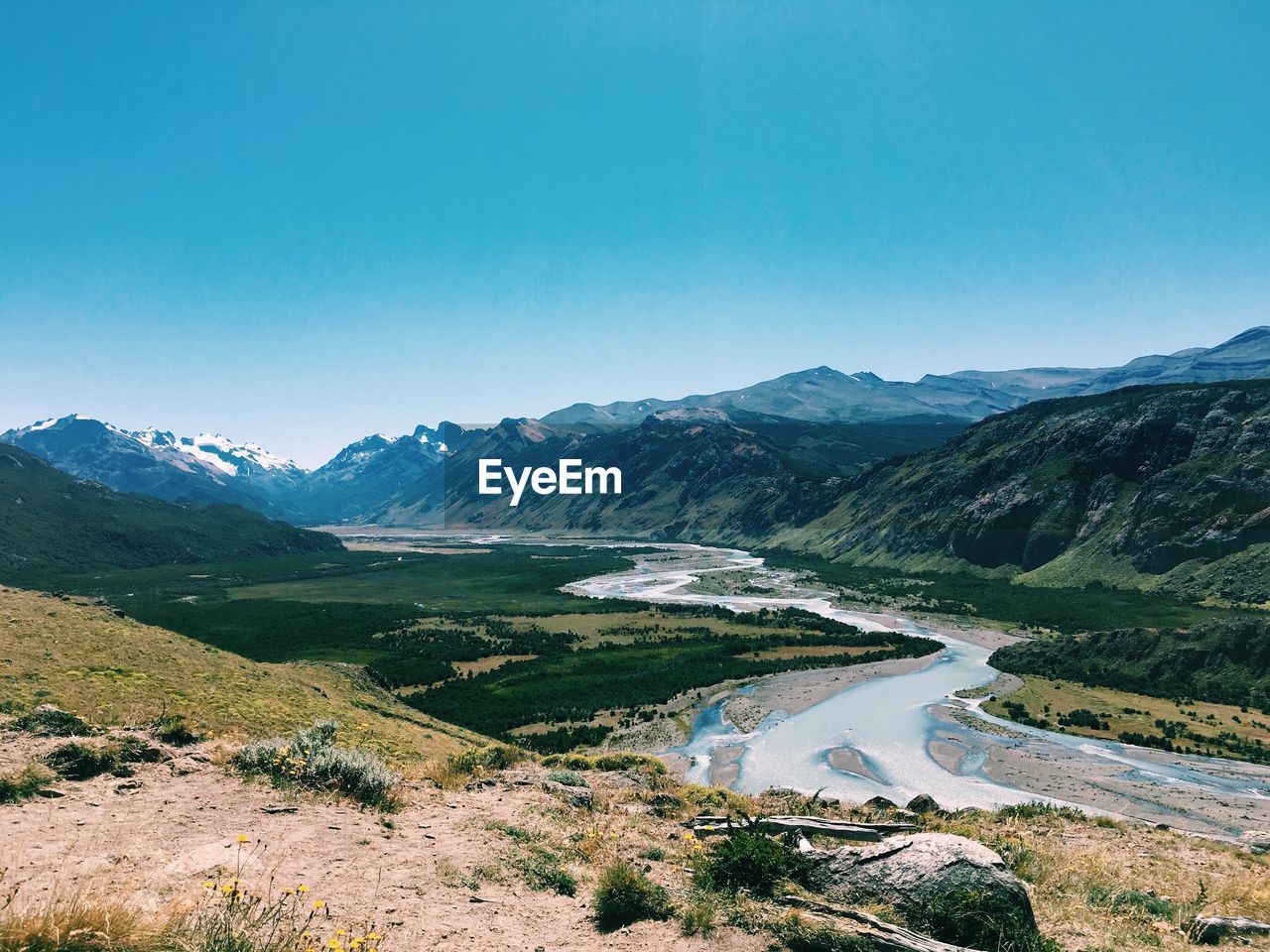 Scenic view of mountains against clear blue sky