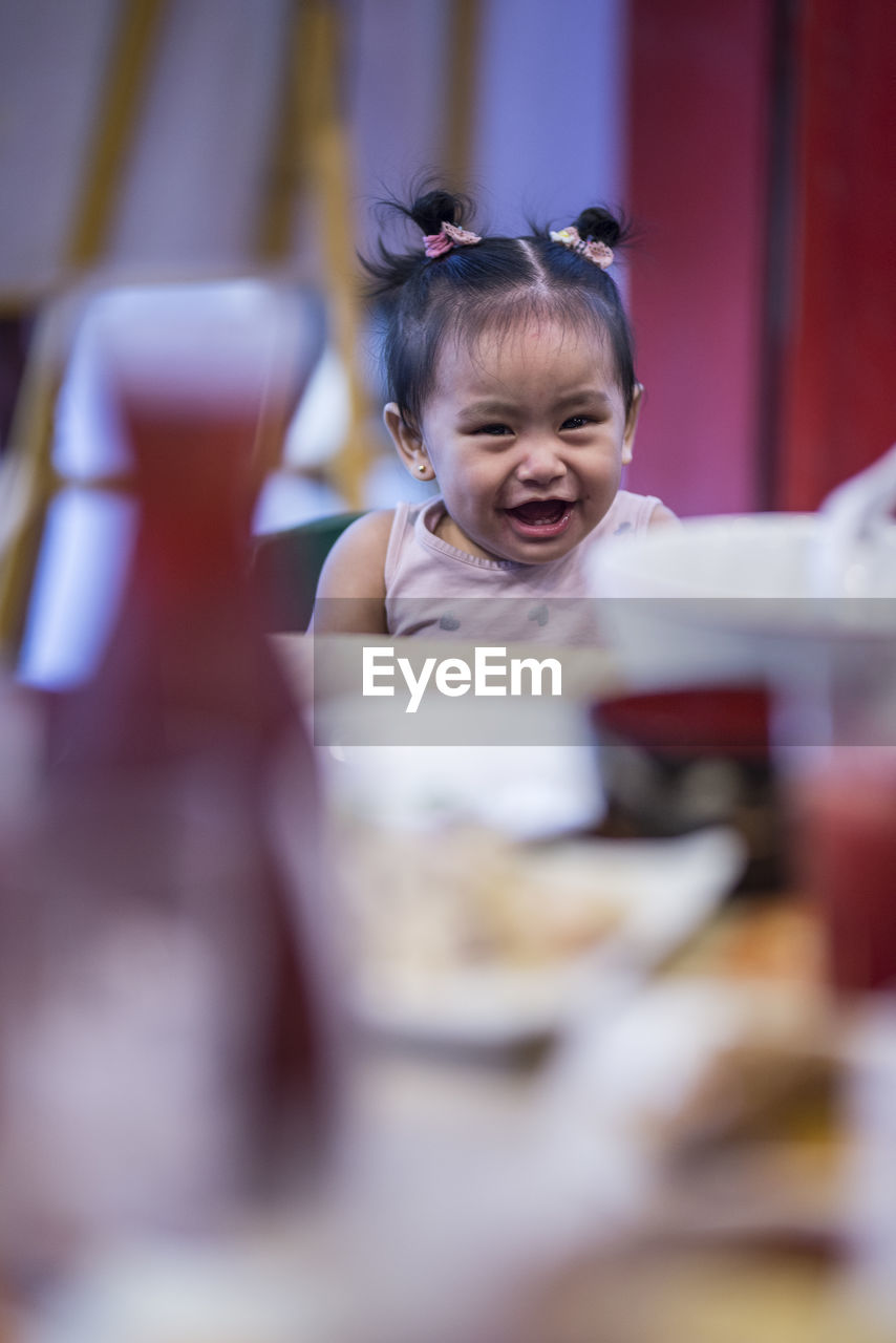Portrait of cute girl at table