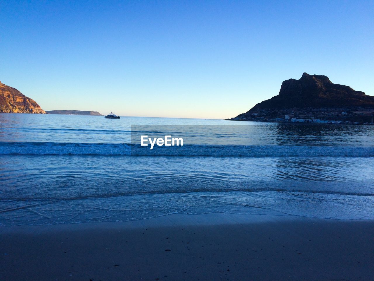 Scenic view of sea against clear blue sky