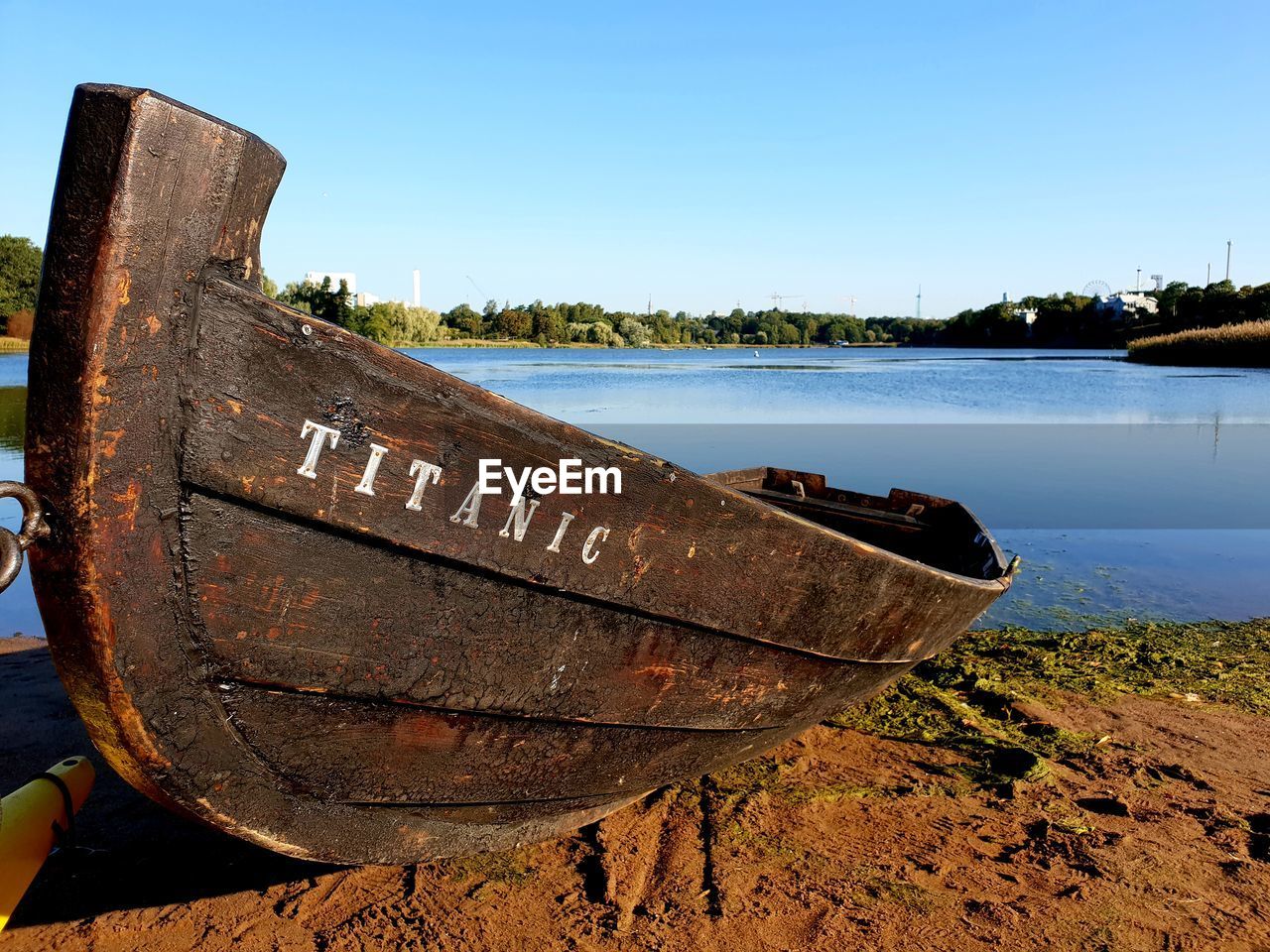 Abandoned boat moored on lake against sky