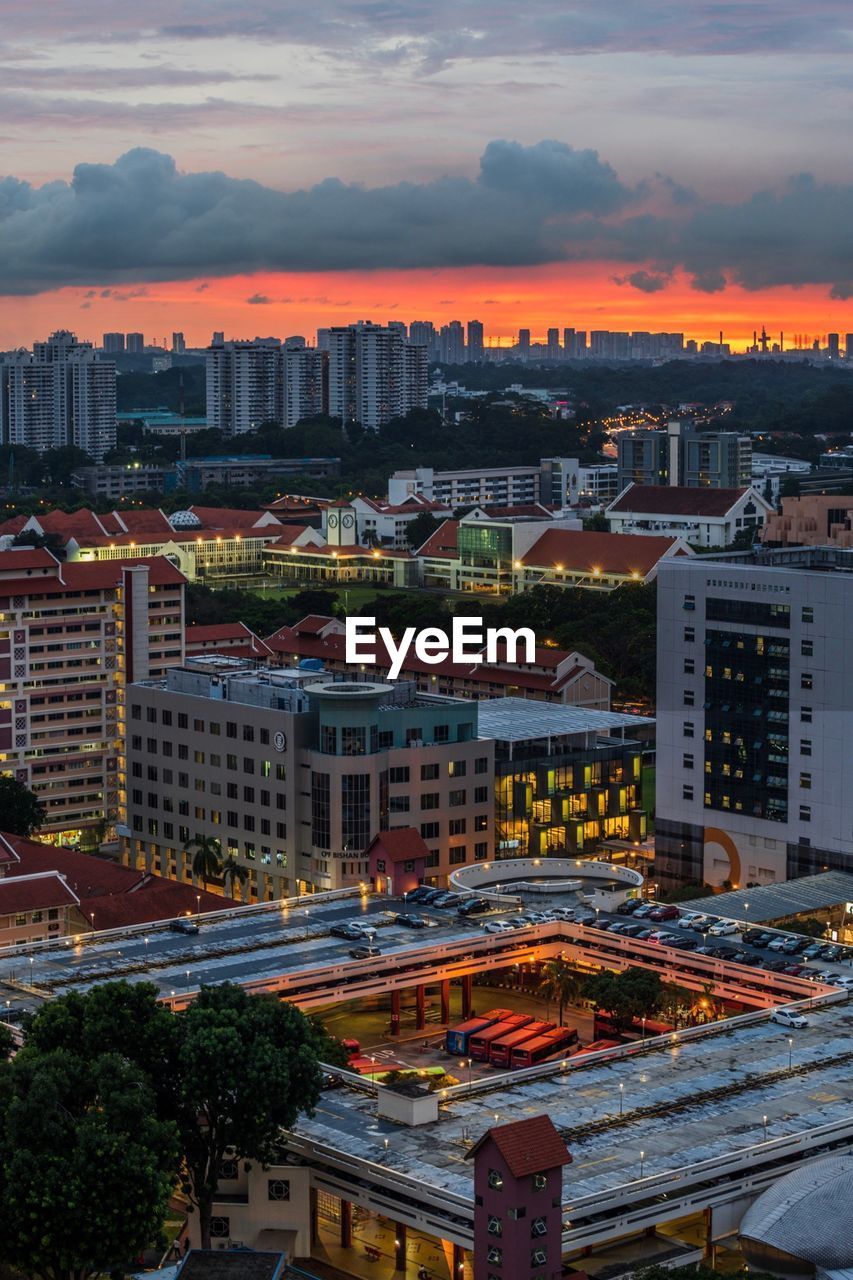 High angle view of illuminated buildings against sky during sunset