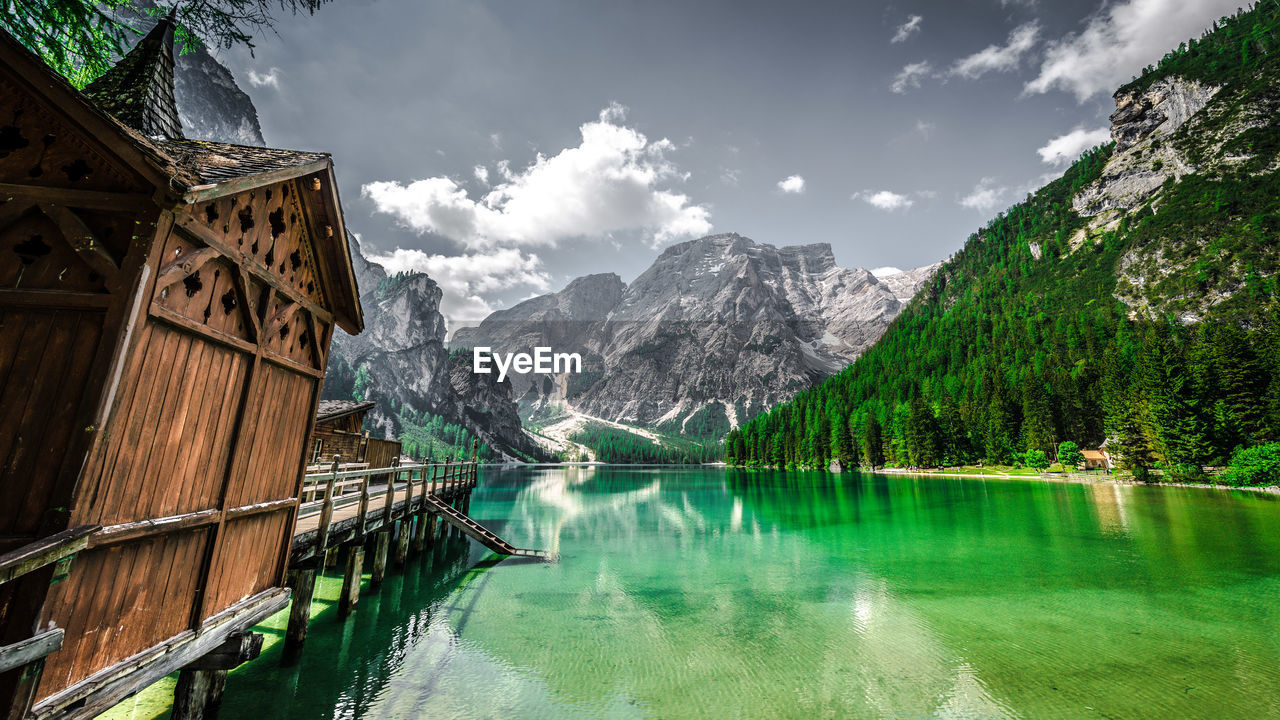 Scenic view of lake pragser wildsee by mountains against sky