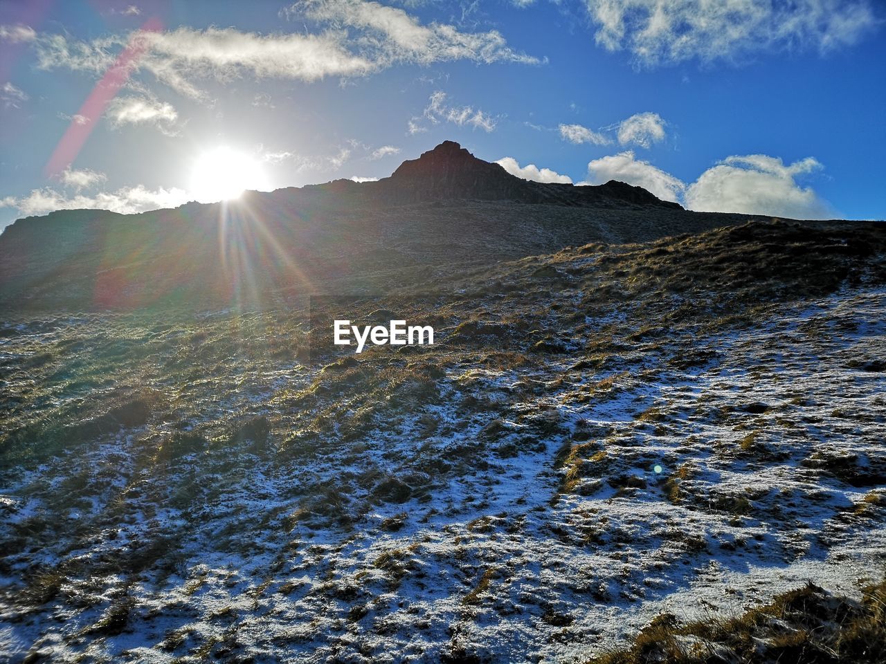 SCENIC VIEW OF MOUNTAINS AGAINST SKY DURING SUNNY DAY