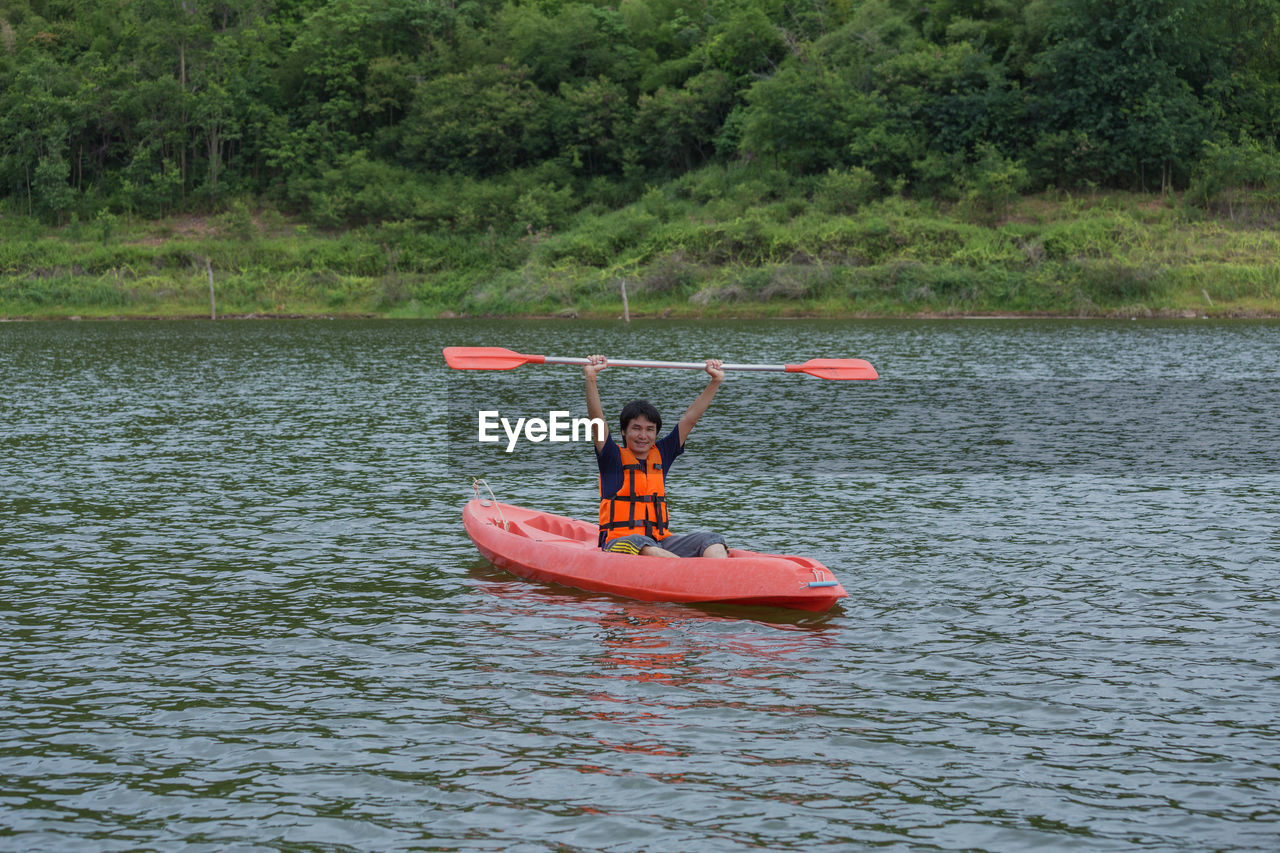 MAN IN BOAT ON LAKE