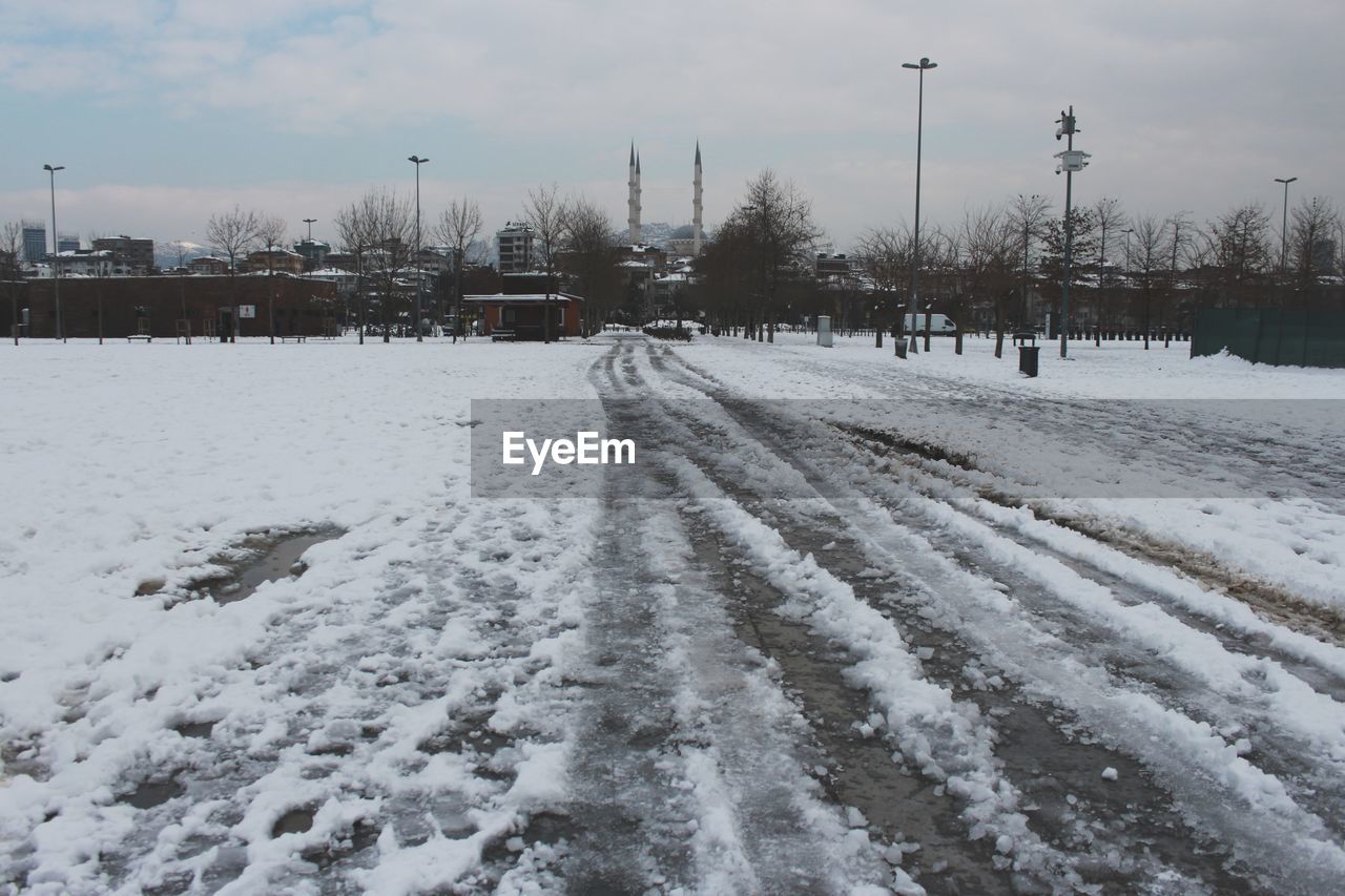 snow, winter, cold temperature, freezing, sky, nature, environment, tree, no people, white, transportation, cloud, architecture, blizzard, frozen, day, city, road, plant, beauty in nature, landscape, scenics - nature, street, winter storm, outdoors, built structure, land, building exterior