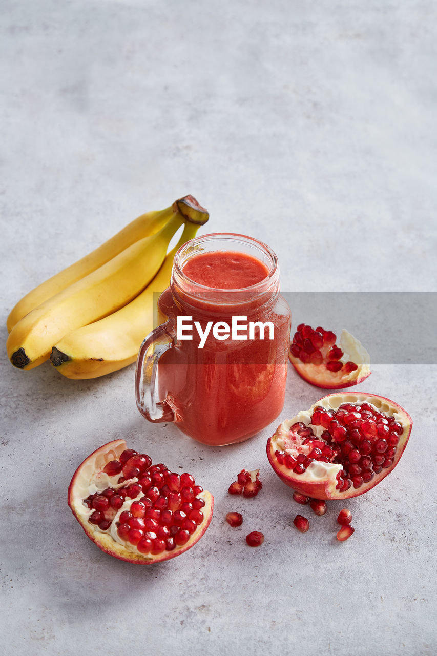 High angle view of fruits with juice on table