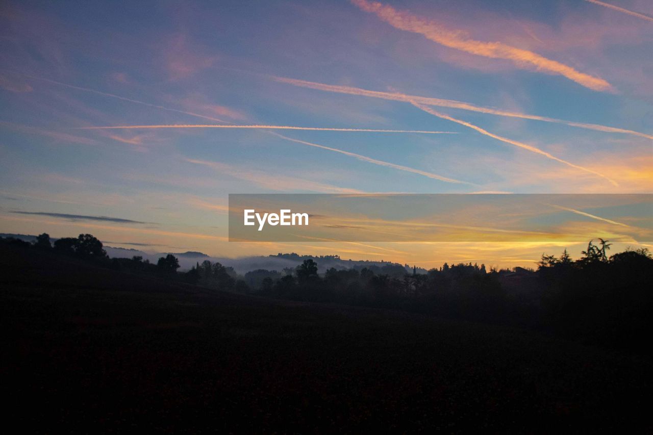 SCENIC VIEW OF SILHOUETTE LANDSCAPE AGAINST SKY DURING SUNSET