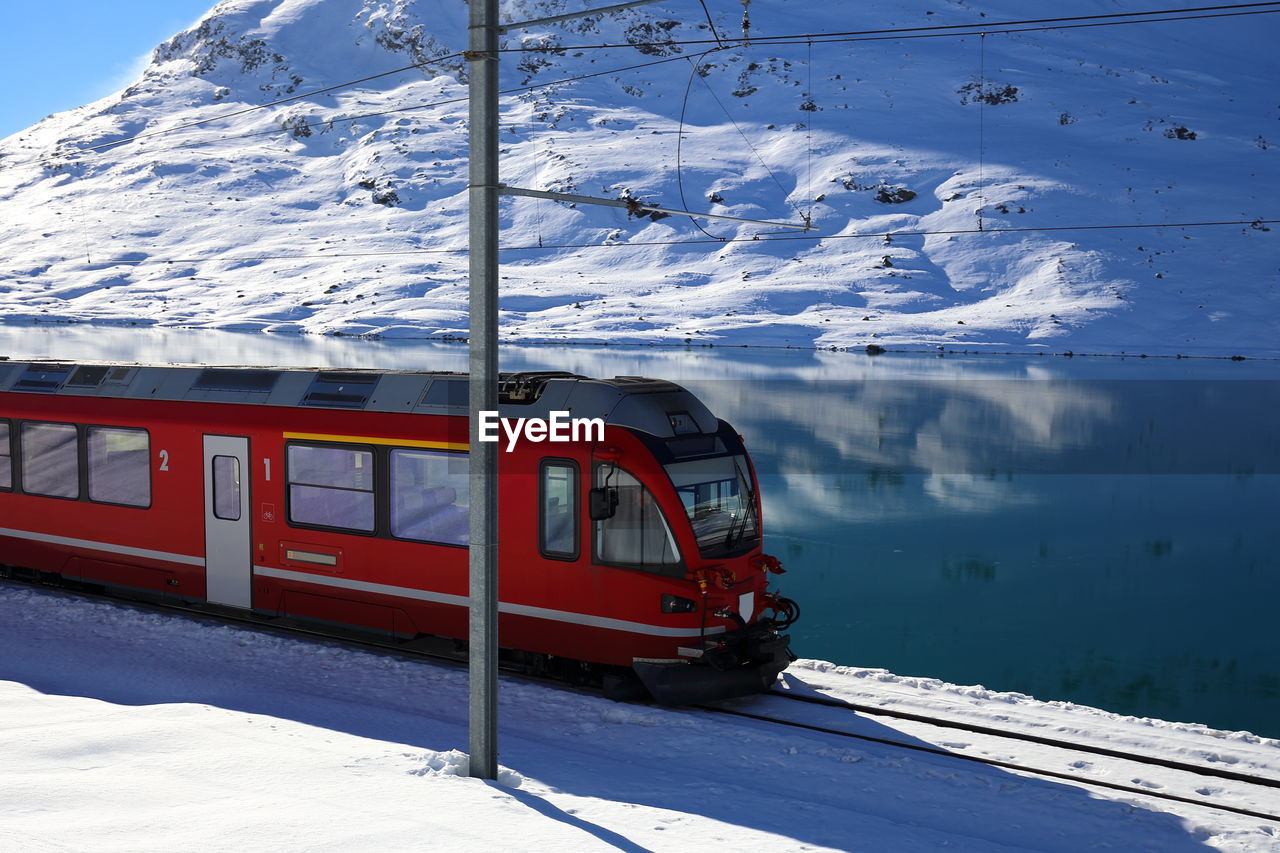 SKI LIFT AGAINST SNOWCAPPED MOUNTAINS