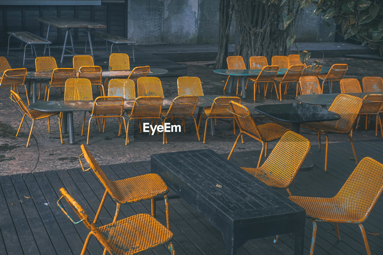 High angle view of chairs and tables at sidewalk cafe