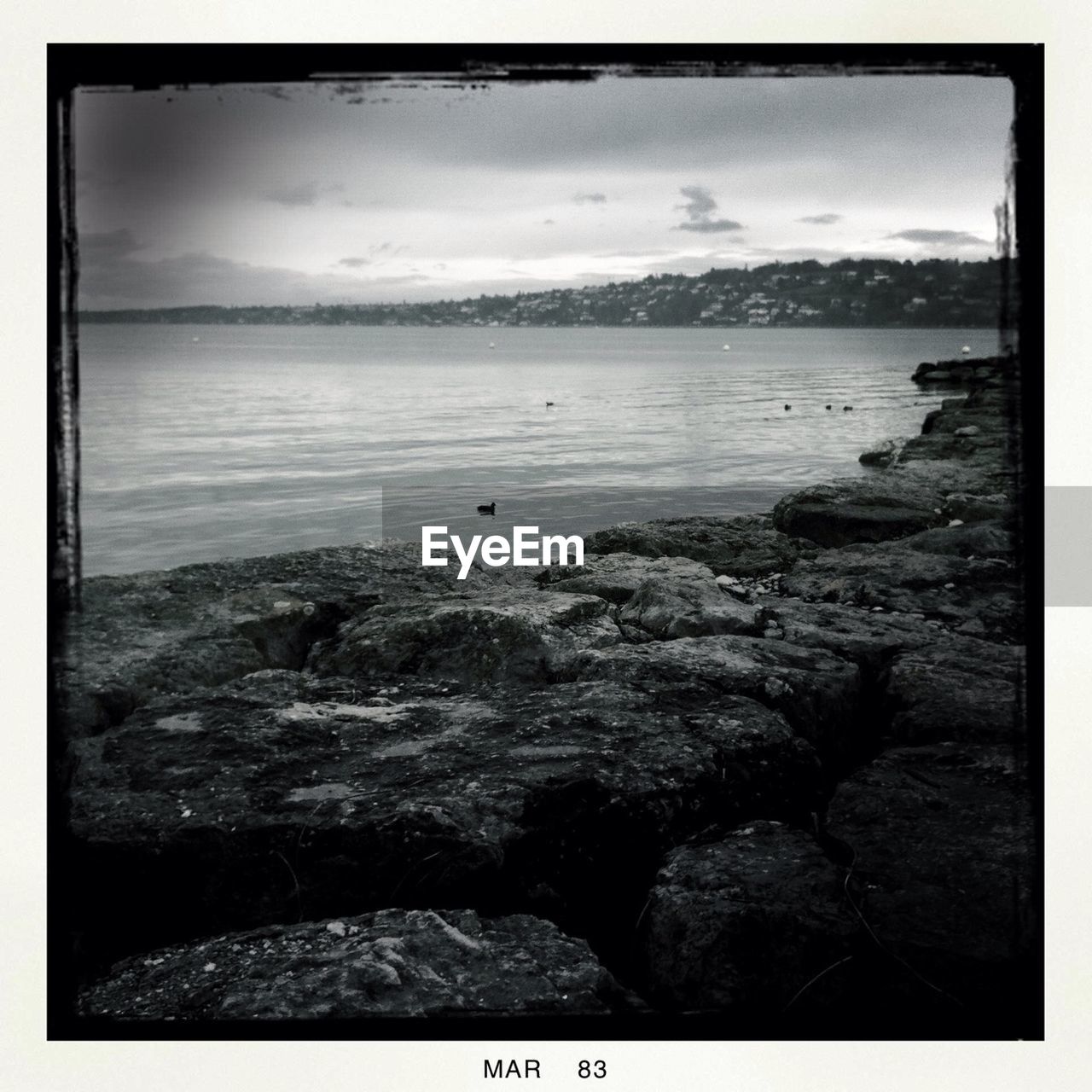 SCENIC VIEW OF SEA WITH MOUNTAIN IN BACKGROUND