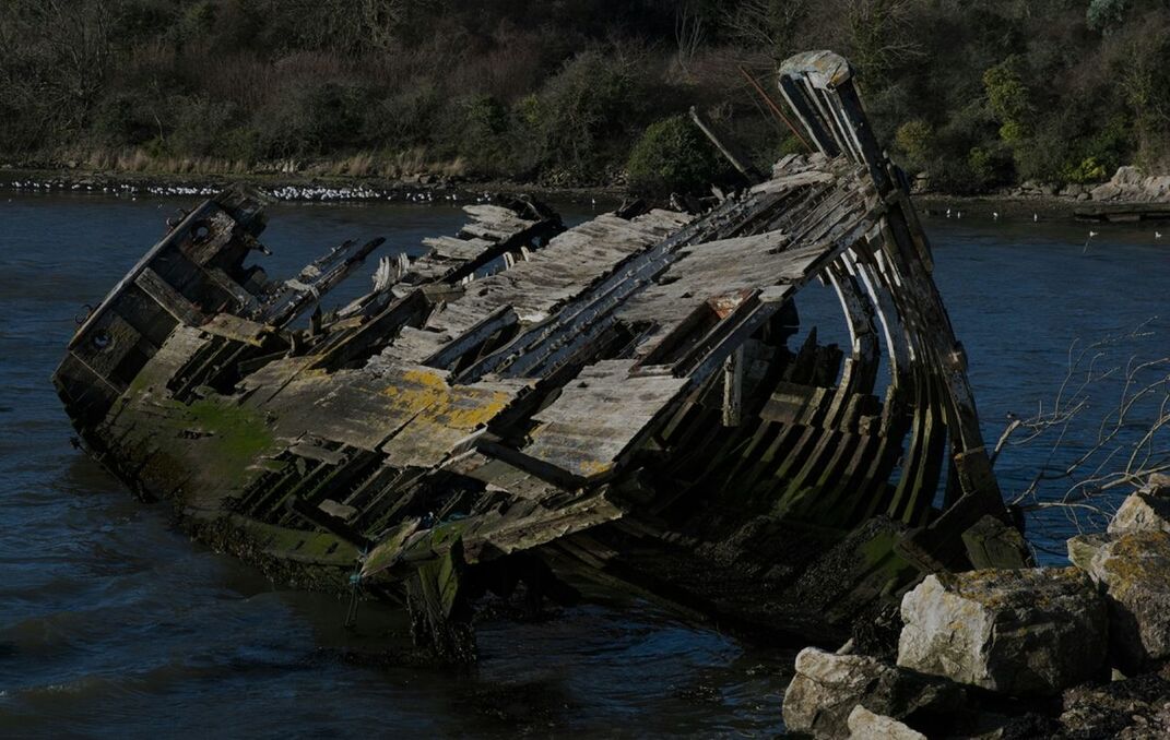 Abandoned boat at lakeshore