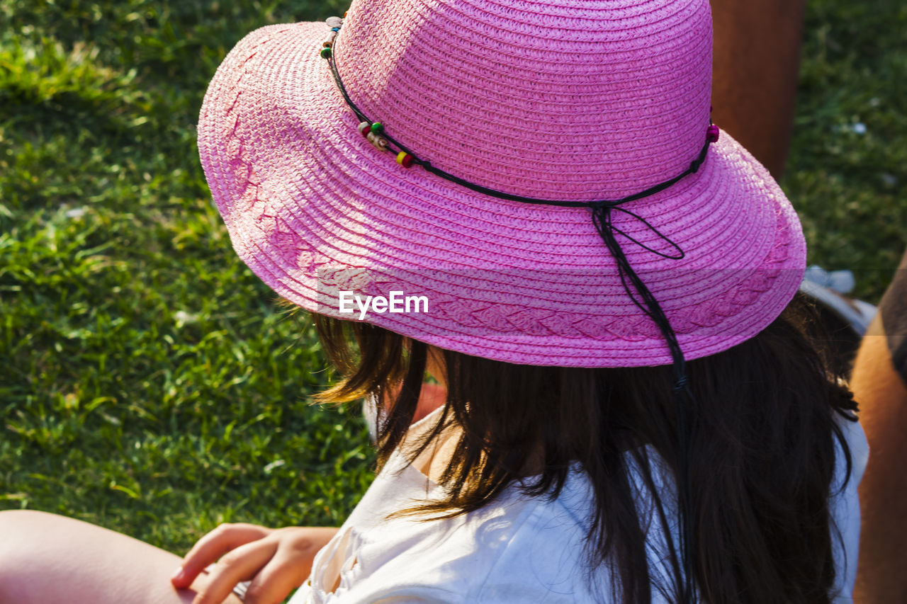 REAR VIEW OF WOMAN WITH HAT