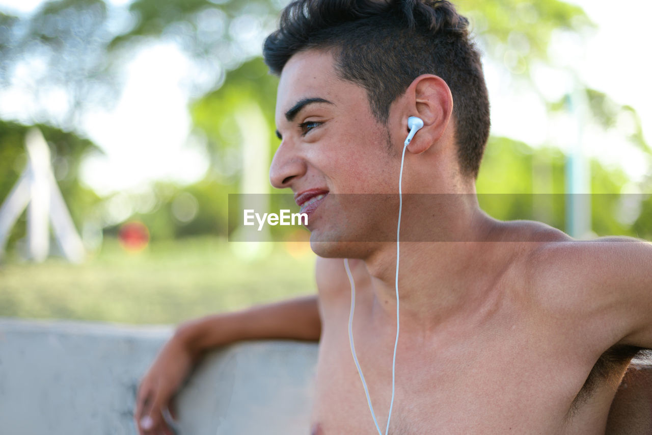 Teenager boy listening to music with earphones