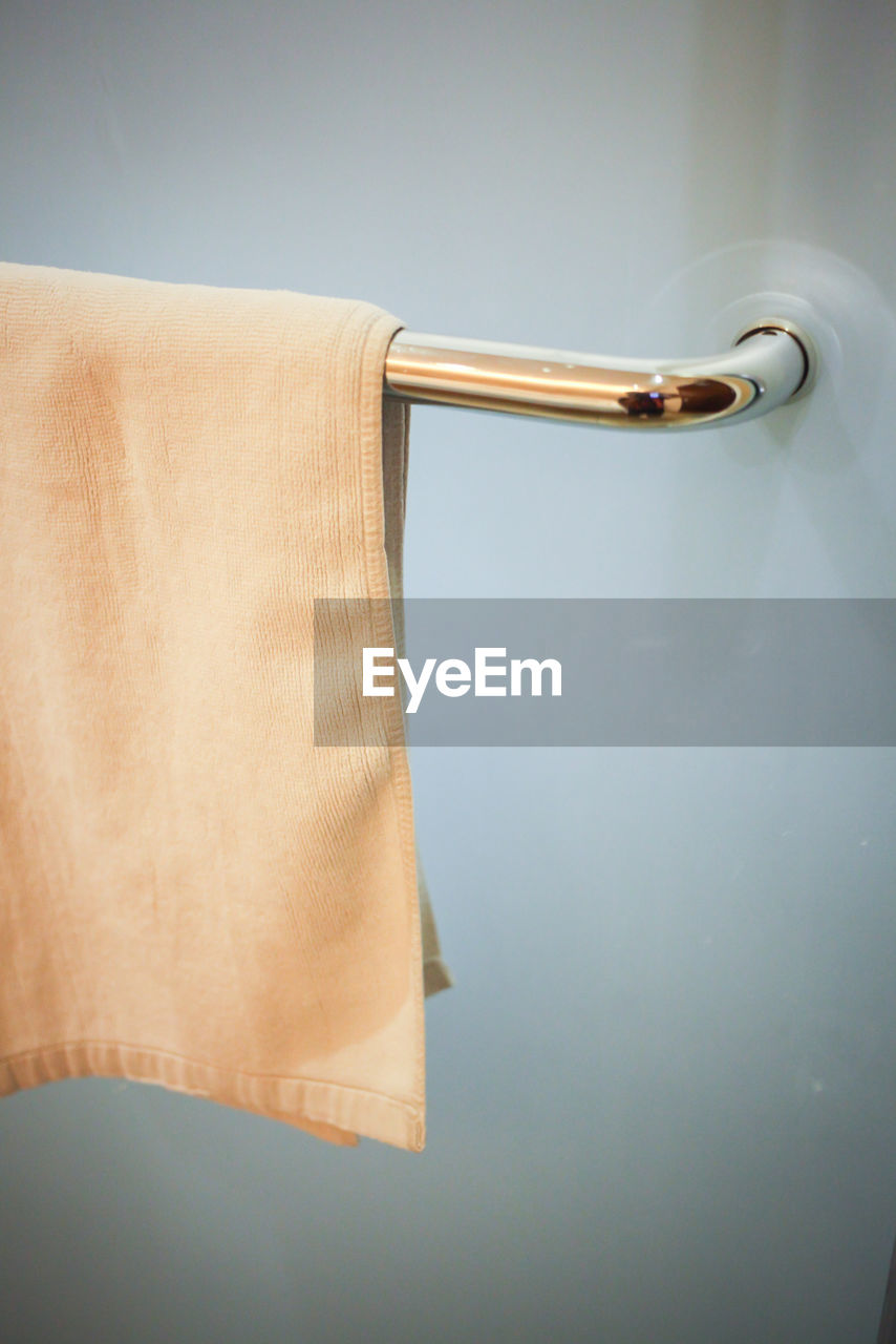 Clean white hand towel on a hanger.