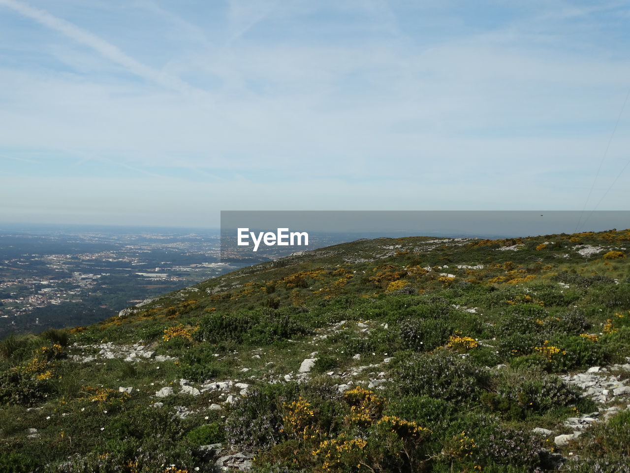 Aerial view of sea and cityscape against sky