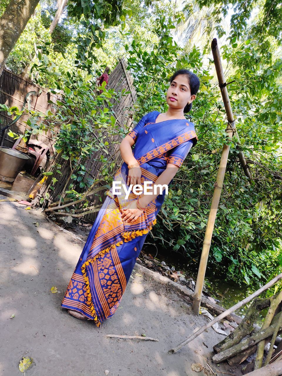 Full length of woman wearing sari standing against tree