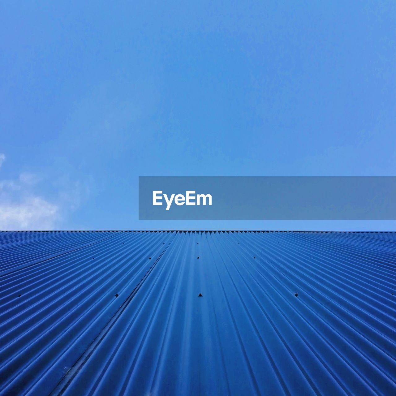 Low angle view of roof against blue sky