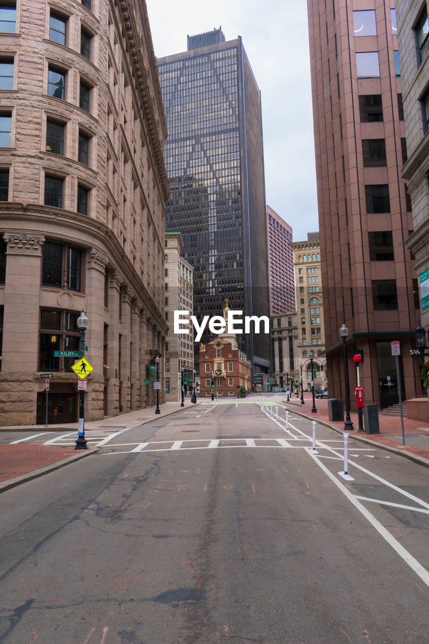 Street amidst buildings against sky