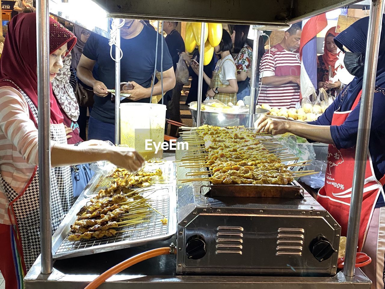 PEOPLE AT MARKET STALL