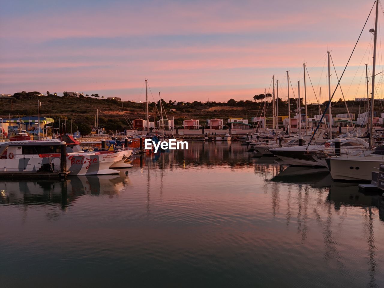BOATS IN HARBOR AT SUNSET