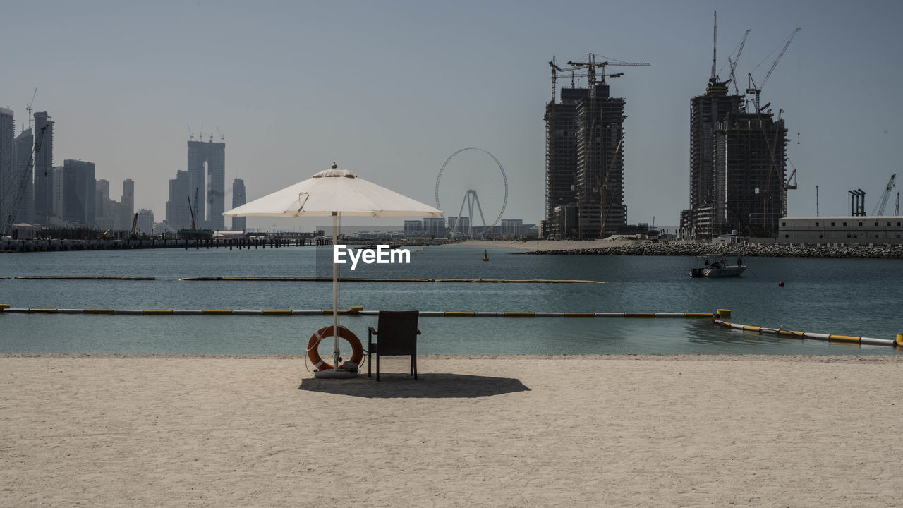 Scenic view of sea and buildings against sky